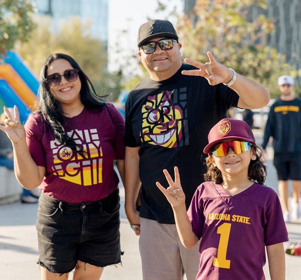 Sun Devil family showing pitchfork hand salute