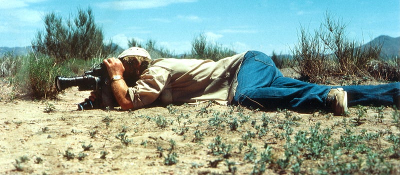 Bert Hölldobler with a camera on the ground.